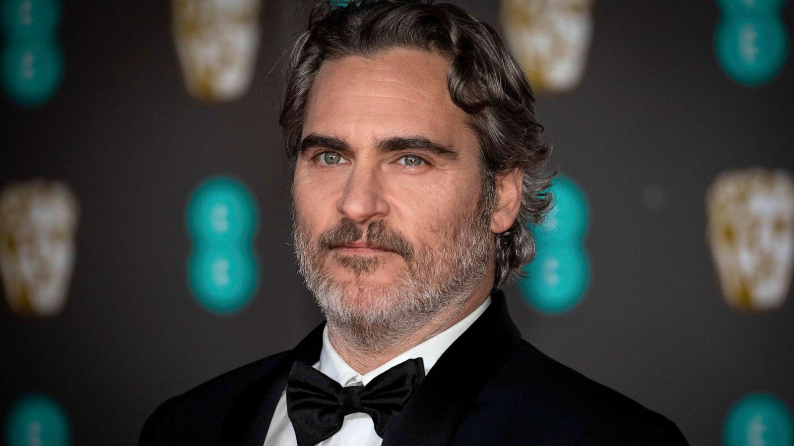 PHOTO: Joaquin Phoenix poses for photographers upon arrival at the Bafta Film Awards, in London, Feb. 2 2020.