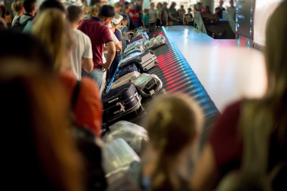 PHOTO: In this undated stock photo, people are seen waiting for their luggage at an airport's baggage claim.