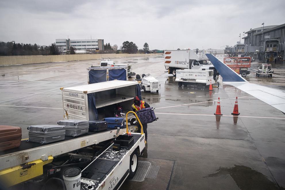 PHOTO: A baggage handler loads luggage onto a passenger plane at Raleigh-Durham International Airport (RDU) in Morrisville, North Carolina, Jan. 20, 2022.