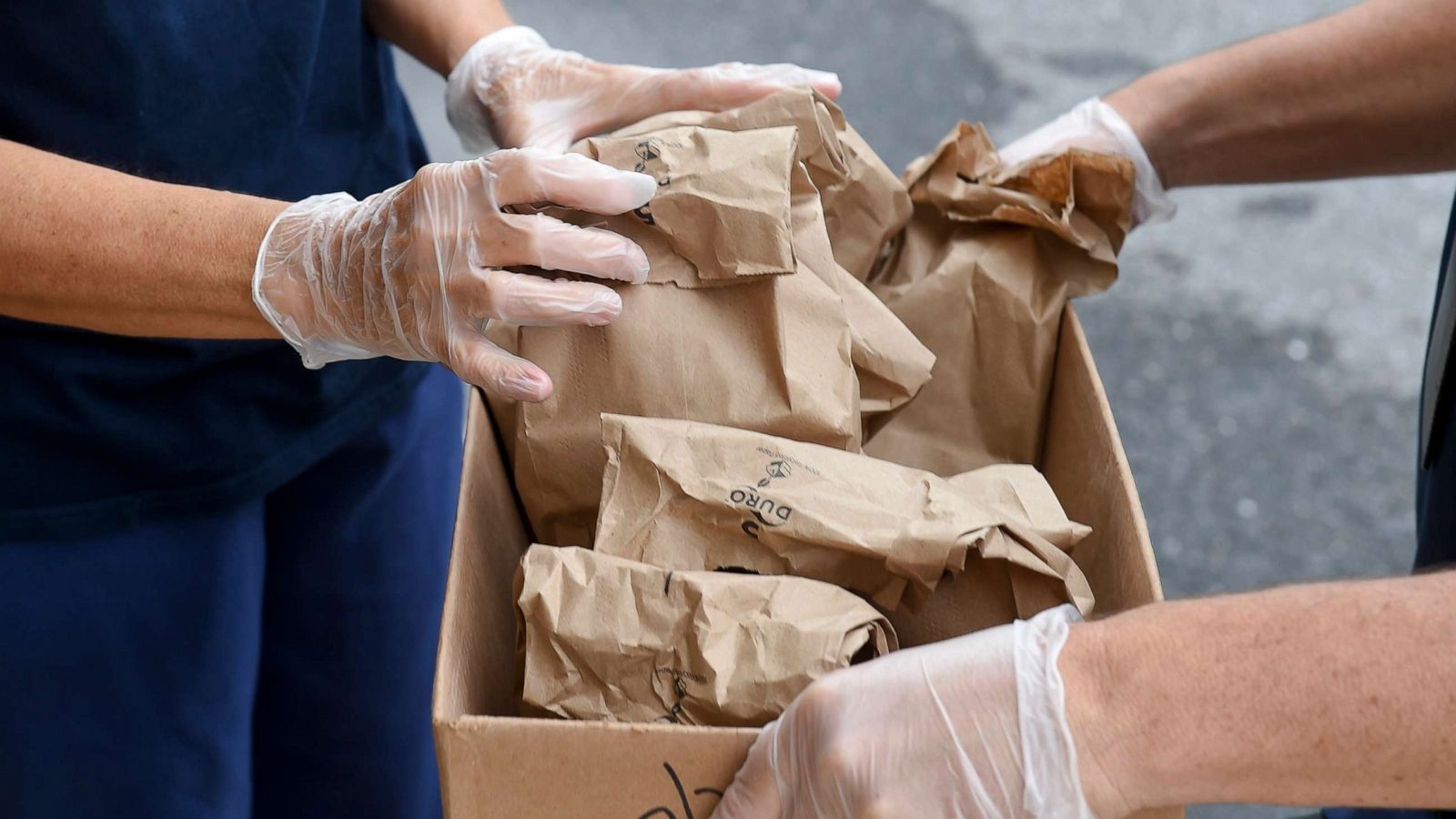 PHOTO: Joan Sandritter, left, a cafeteria worker for the school district, and Carey Kline, the director of Food Service and Nutrition in the Muhlenberg school district, load grab and go breakfasts and lunches into a box to distribute, Sept. 10, 2021.