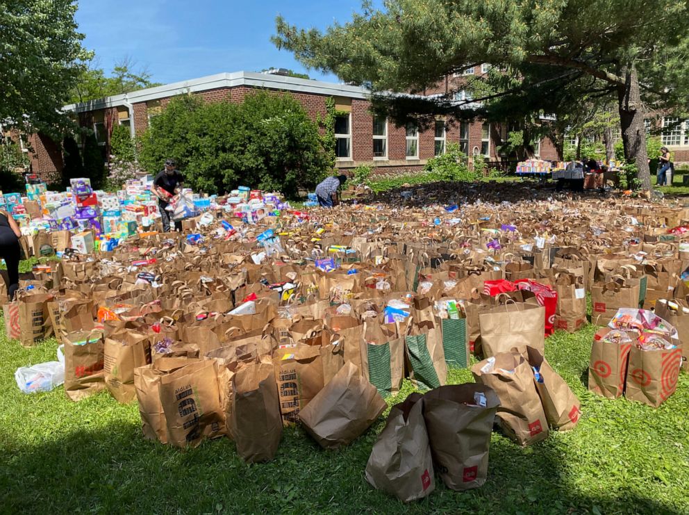 PHOTO: Donated food fills the parking lot and grass field at Sanford Middle School in Minneapolis.