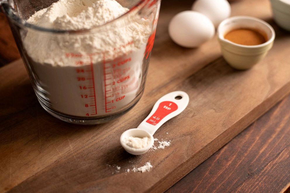 PHOTO: Flour spills over a measuring spoon in this stock image.