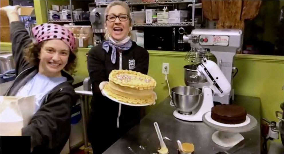 PHOTO: Tina Cromwell finishes off a gluten-free chocolate peanut butter cake with sprinkles at Bam Bam Bakery in Portland, Maine. 