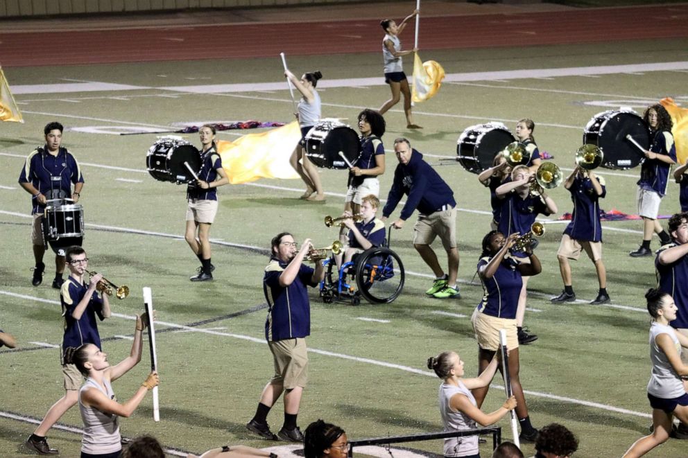 PHOTO: Mewhorter and Casey have learned through trial and error how to work together so Casey can be a "full participant" in Southmoore's marching band.