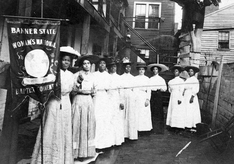 PHOTO: Nine African-American women pose for a photo with Nannie Burroughs, holding a banner that reads, "Banner State Woman's National Baptist Convention," circa 1905.