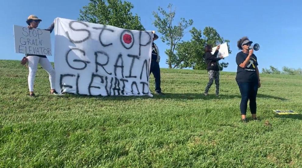 PHOTO: Joy Banner protests against the installation of a grain facility in their backyard.