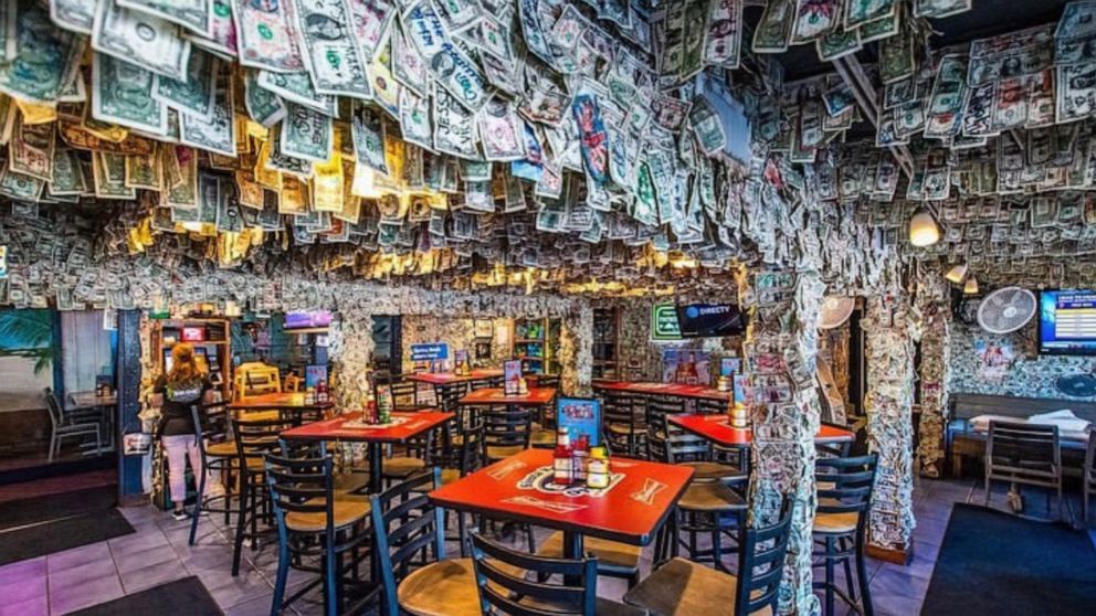 Siesta Key Oyster Bar in Sarasota, Florida, has made it a novelty tradition for patrons to write messages on dollar bills and secure them to its ceiling and walls.