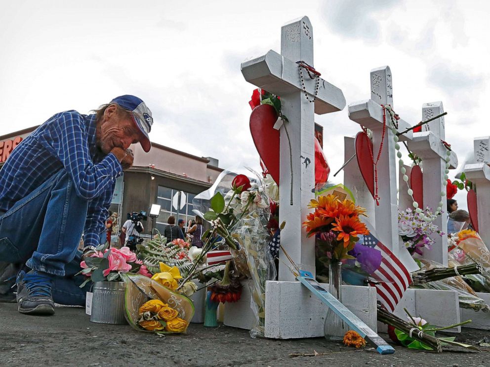 PHOTO: Antonio Basbo kneels in front of the cross for his partner Margie Reckard at the make shift memorial honoring the victims of the mass shooting in El Paso, Texas, Aug. 6 2019.