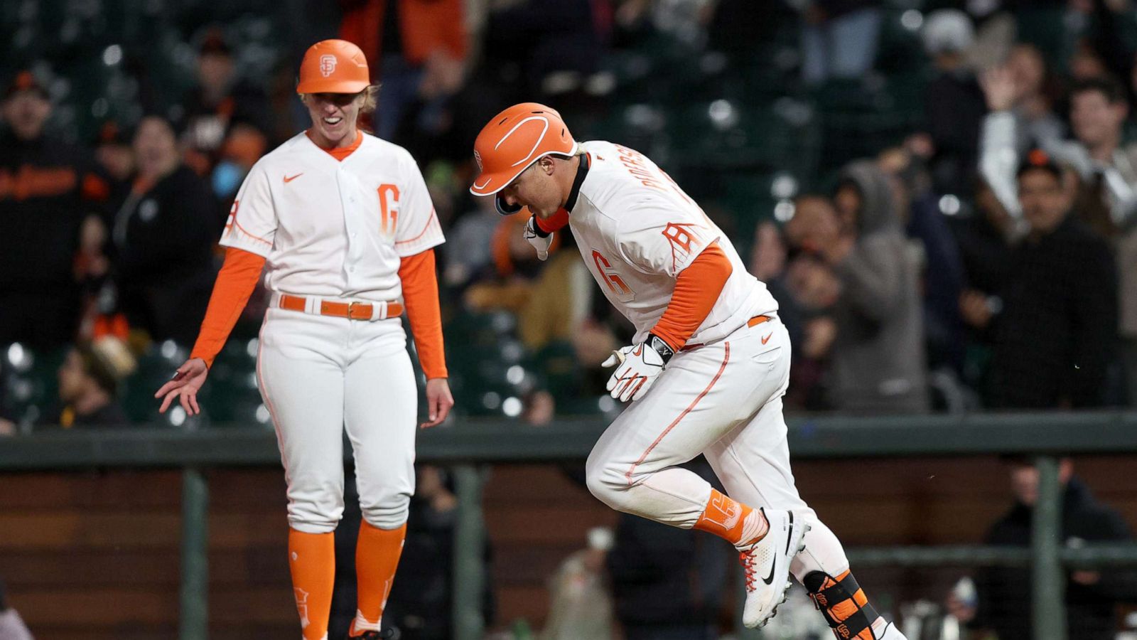 PHOTO: Joc Pederson of the San Francisco Giants reacts as passes first base coach Alyssa Nakken at Oracle Park, April 12, 2022, in San Francisco, Calif.