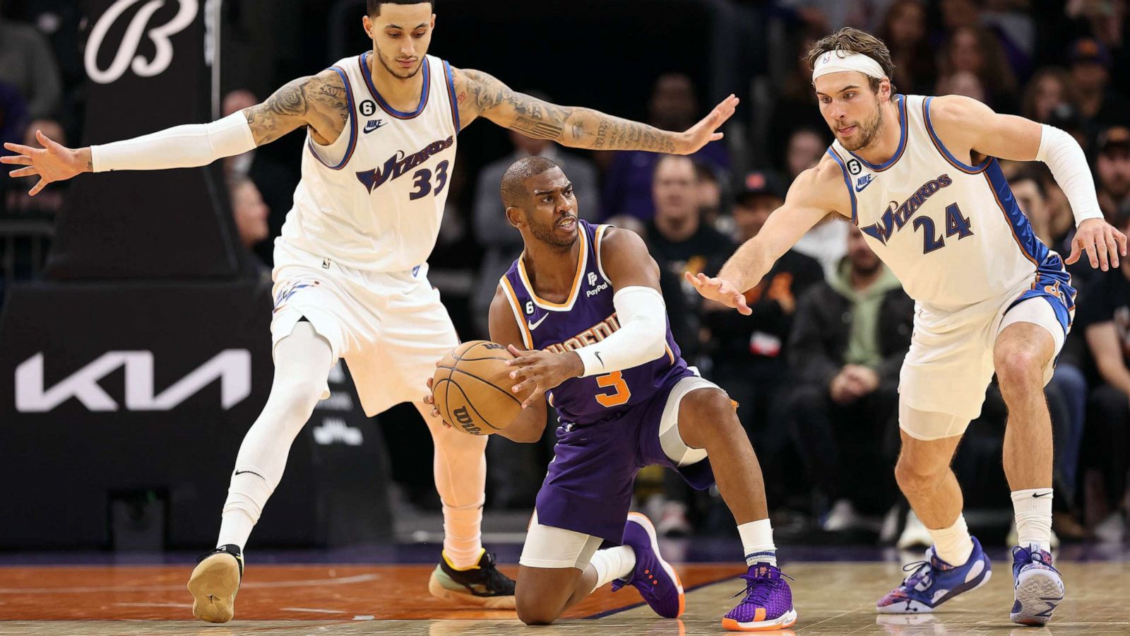 PHOTO: FILE - Chris Paul #3 of the Phoenix Suns looks to pass under pressure from Kyle Kuzma #33 and Corey Kispert #24 of the Washington Wizards during the second half of the NBA game at Footprint Center, Dec. 20, 2022 in Phoenix.