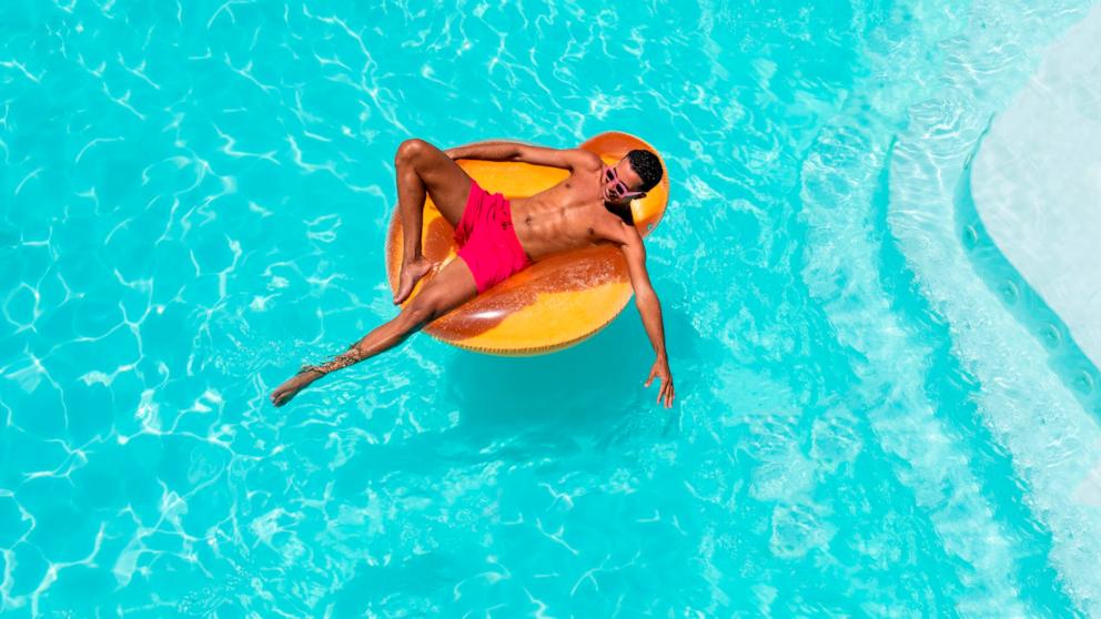 PHOTO: Man with inflatable float in swimming pool