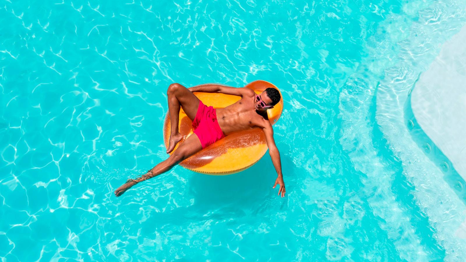 PHOTO: Man with inflatable float in swimming pool