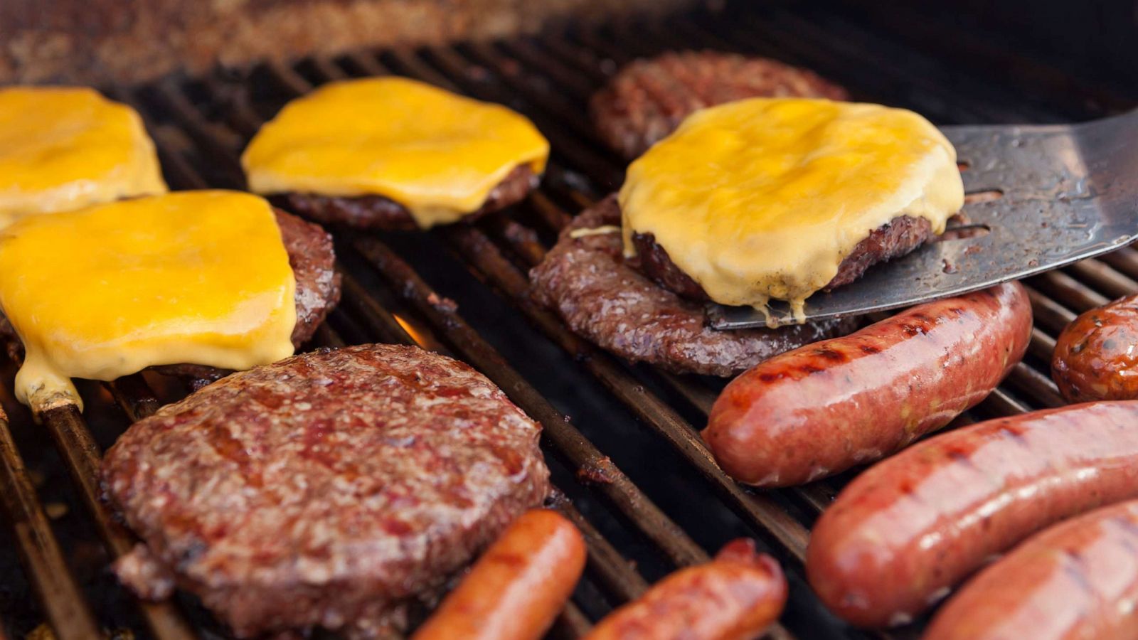 PHOTO: In this undated file photo hotdogs, sausages, hamburgers and cheeseburgers are seen on a barbeque.