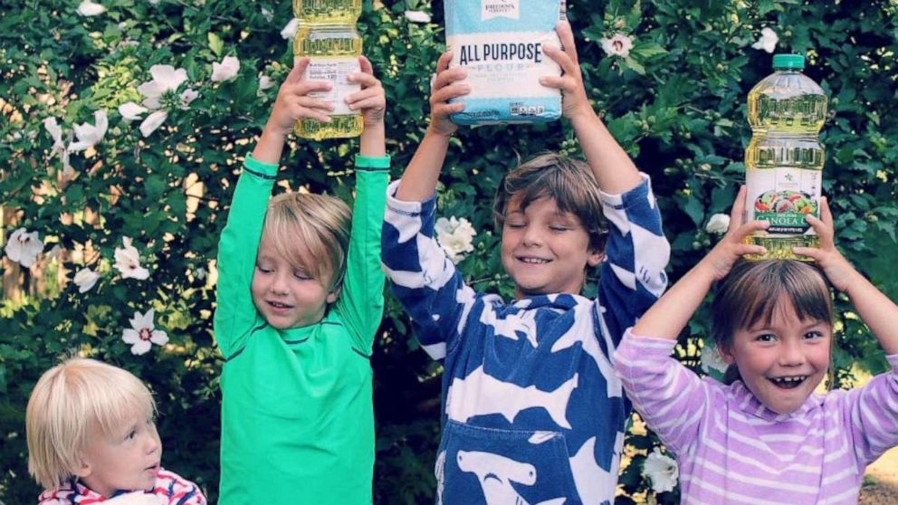 PHOTO: Sterling and Amber Marchand's four children hold food the family has collected for their Be The Good Project.