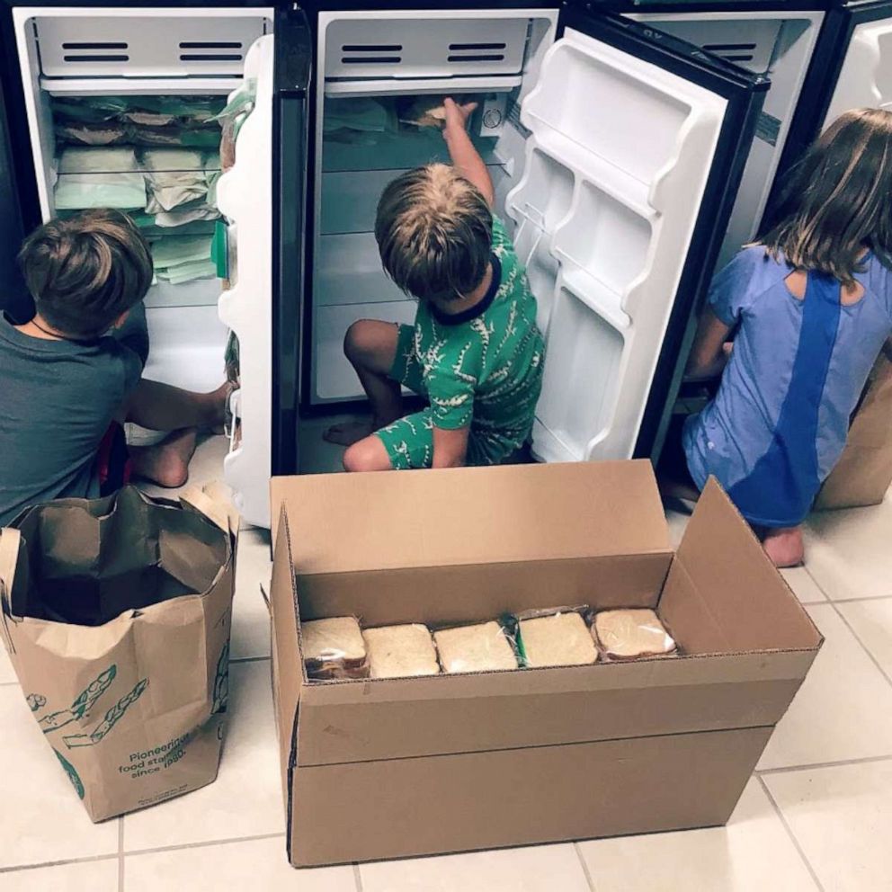 PHOTO: Sterling and Amber Marchand's children stock mini-refrigerators with food that has been donated.