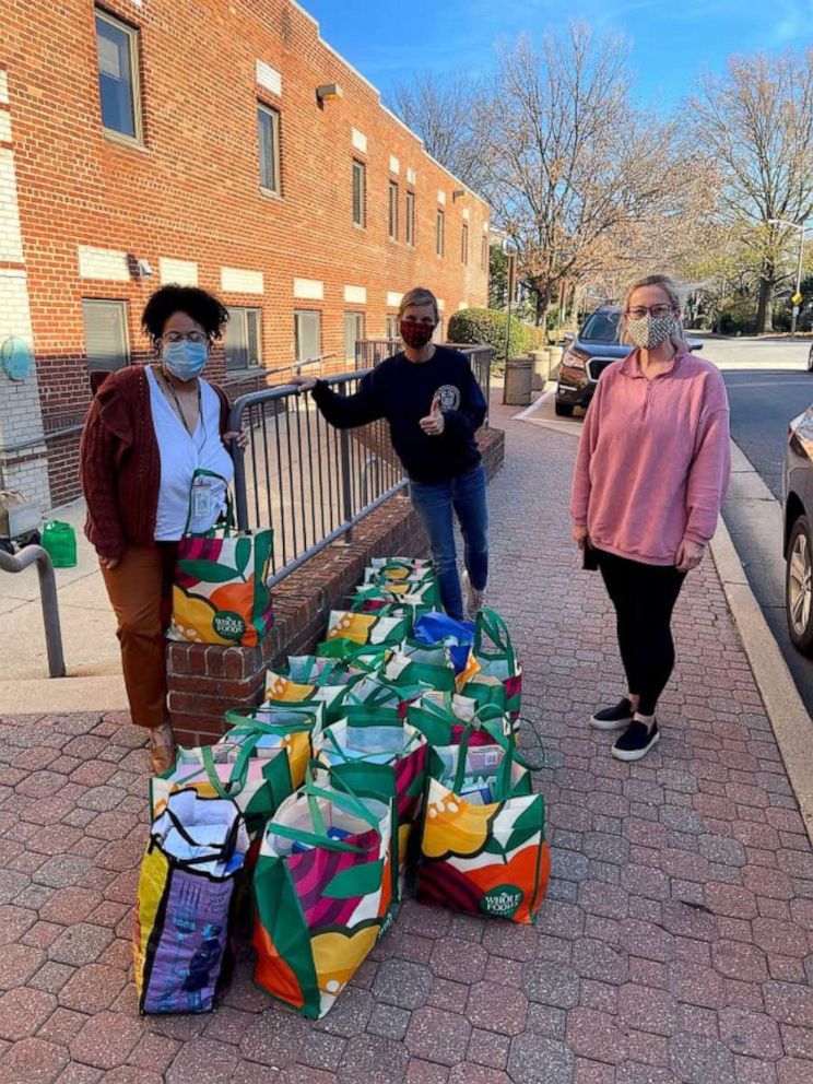 PHOTO: Amber Marchand, center, drops off food her family has collected.