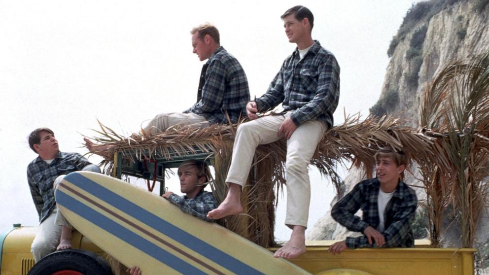 PHOTO: Rock and roll band "The Beach Boys" pose for a portrait with a vintage station wagon in August 1962 in Los Angeles.