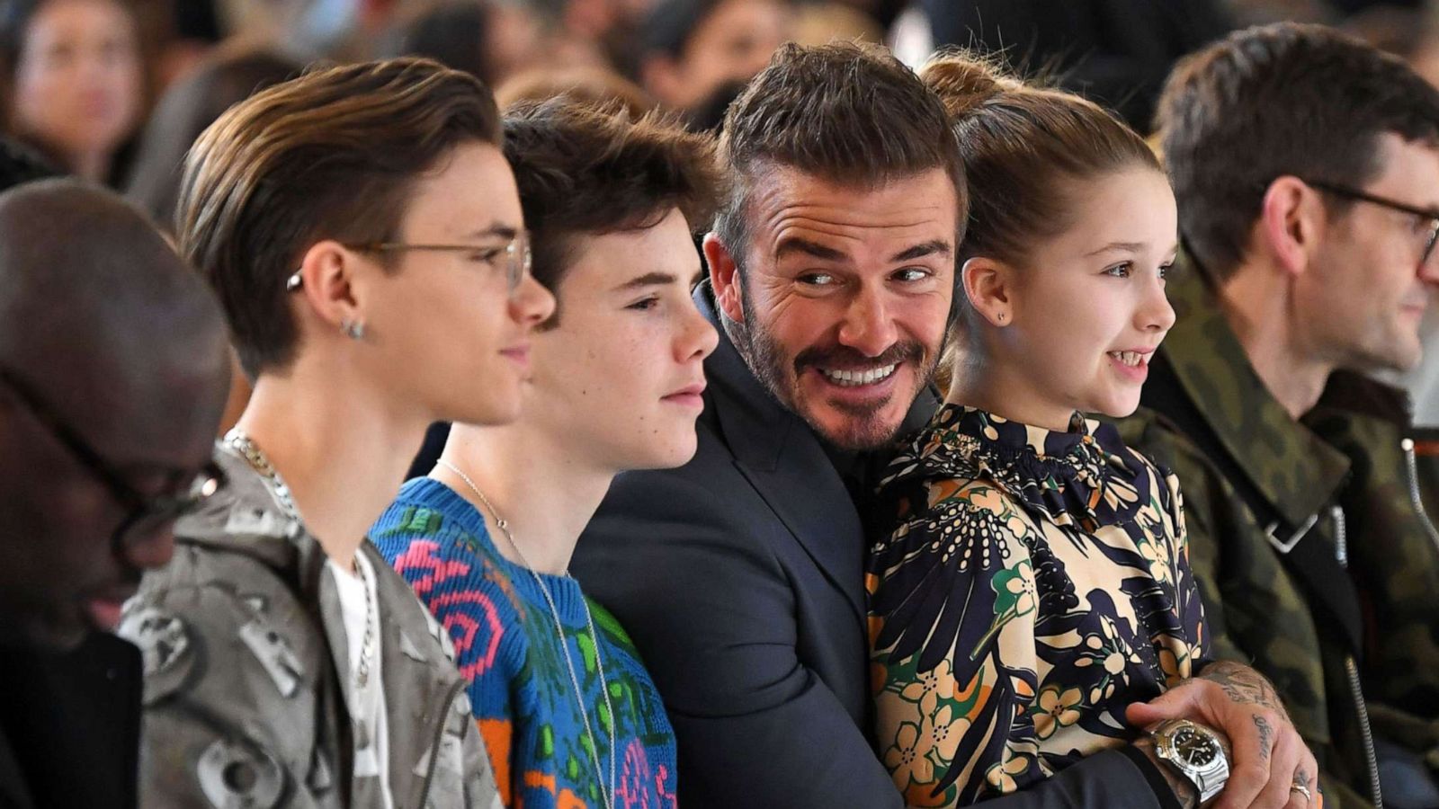 PHOTO: Romeo Beckham, Cruz Beckham, David Beckham and Harper Beckham take their seats in the front row for the catwalk show by fashion house Victoria Beckham during their Autumn/Winter 2020 collection at London Fashion Week in London on Feb. 16, 2020.