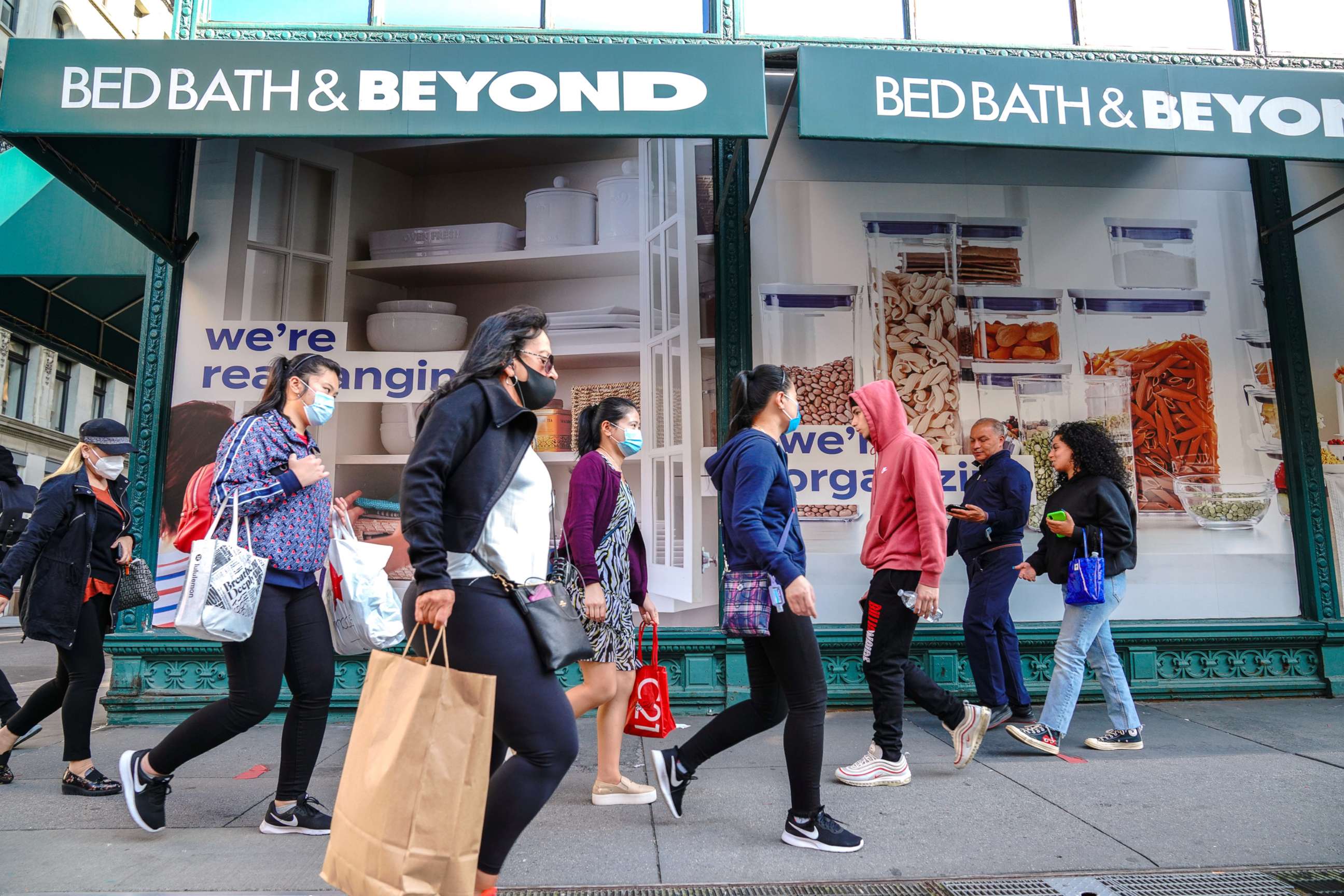 PHOTO: In this Sept. 22, 2020, file photo, people wearing face masks walk past a Bed Bath & Beyond store in New York.