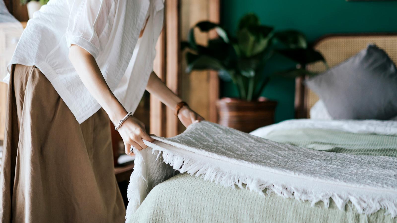 PHOTO: Stock photo of a woman making a bed.