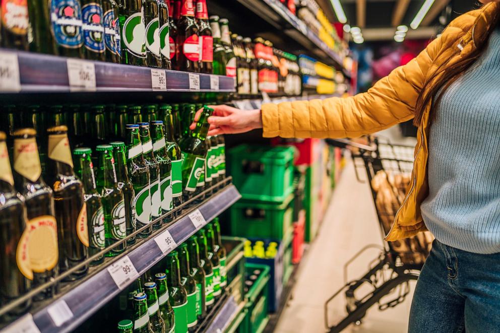 PHOTO: Woman customer in alcohol section in supermarket or liquor store seen in this undated photo.