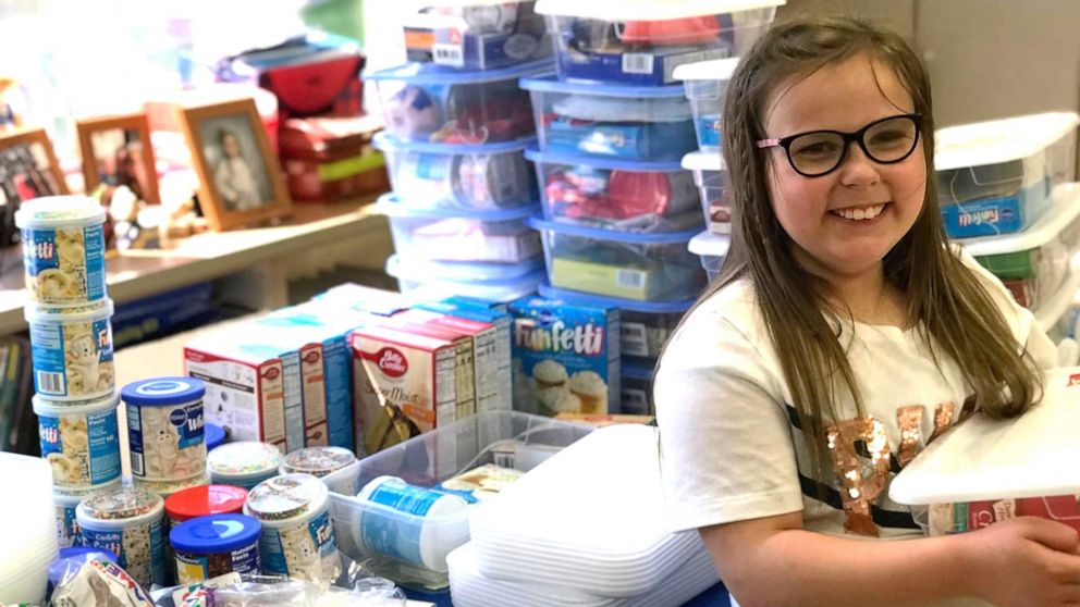 Bella Smith, 9, a third grade students at Wyan-Pine Grove Elementary School in Kentucky, packs boxes with balloons, cake mix and other party supplies for her less fortunate classmates.