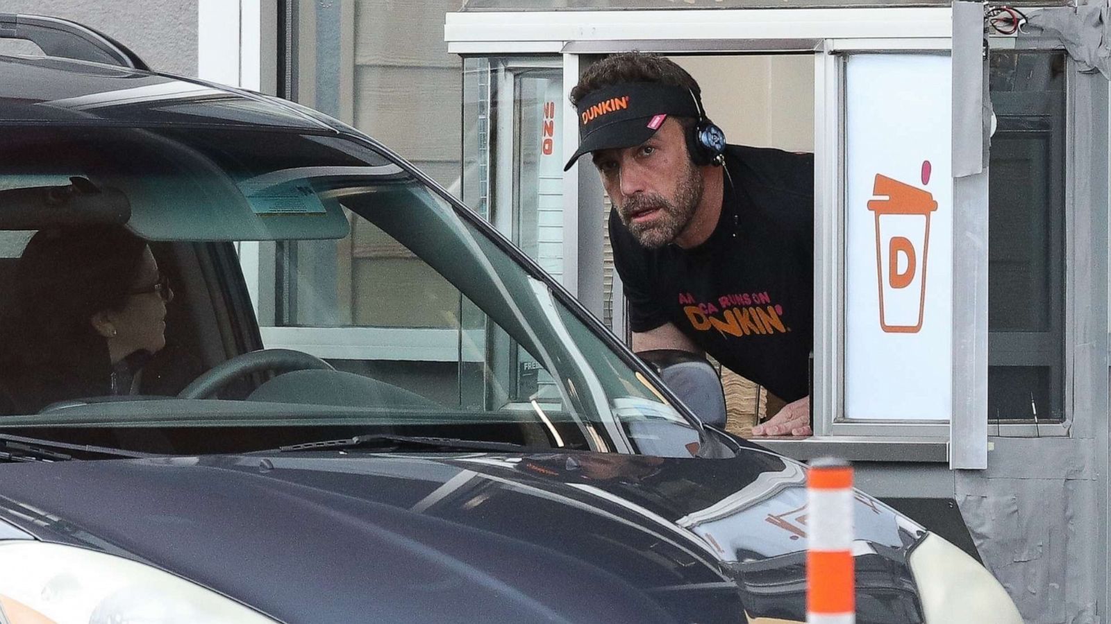 PHOTO: Ben Affleck works the drive-through window at Dunkin Donuts, Jan. 10, 2023, in Boston.