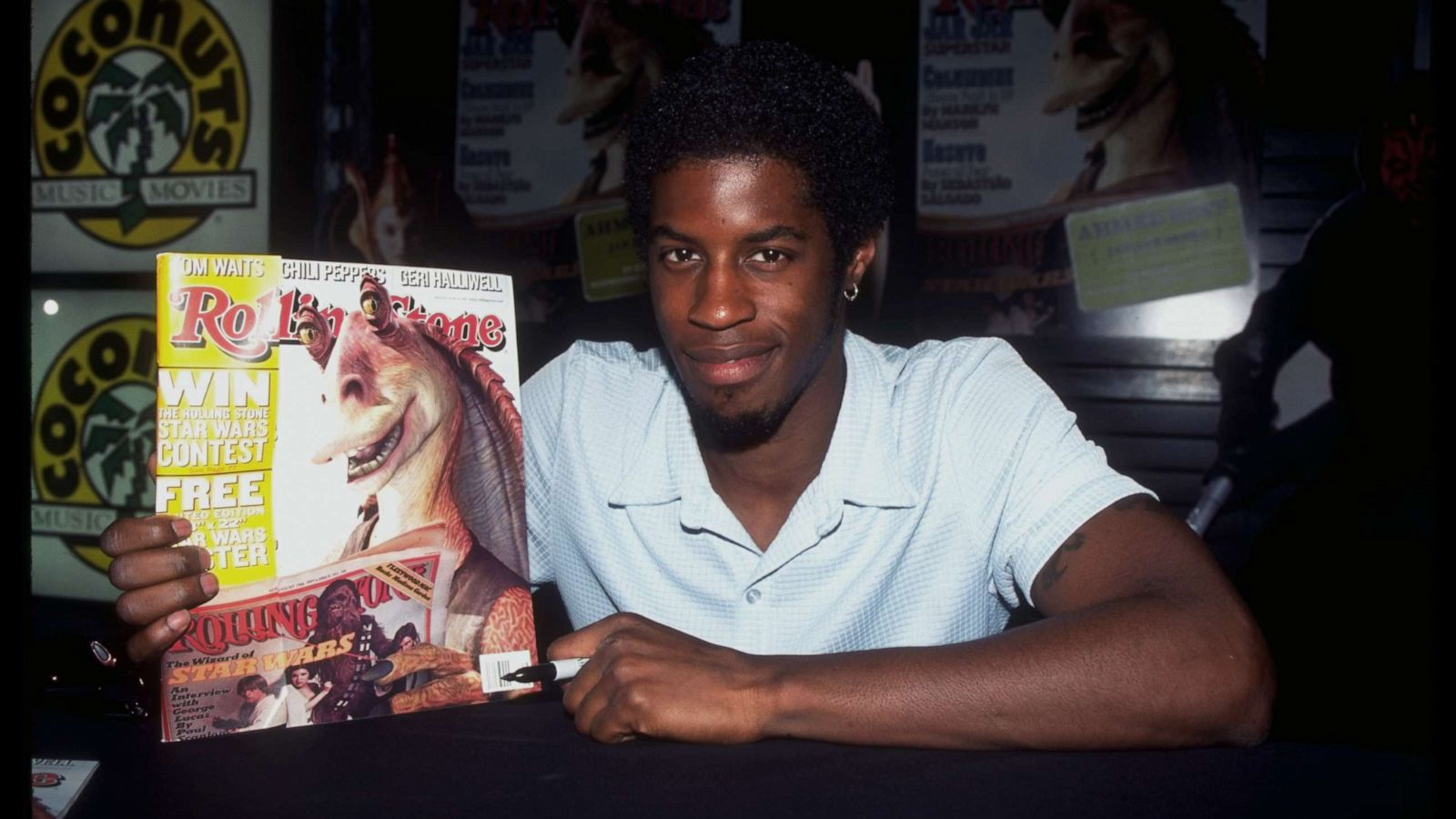 PHOTO: Ahmed Best autographs the "Rolling Stone" cover featuring JarJar Binks at Coconuts music store, June 9, 1999.