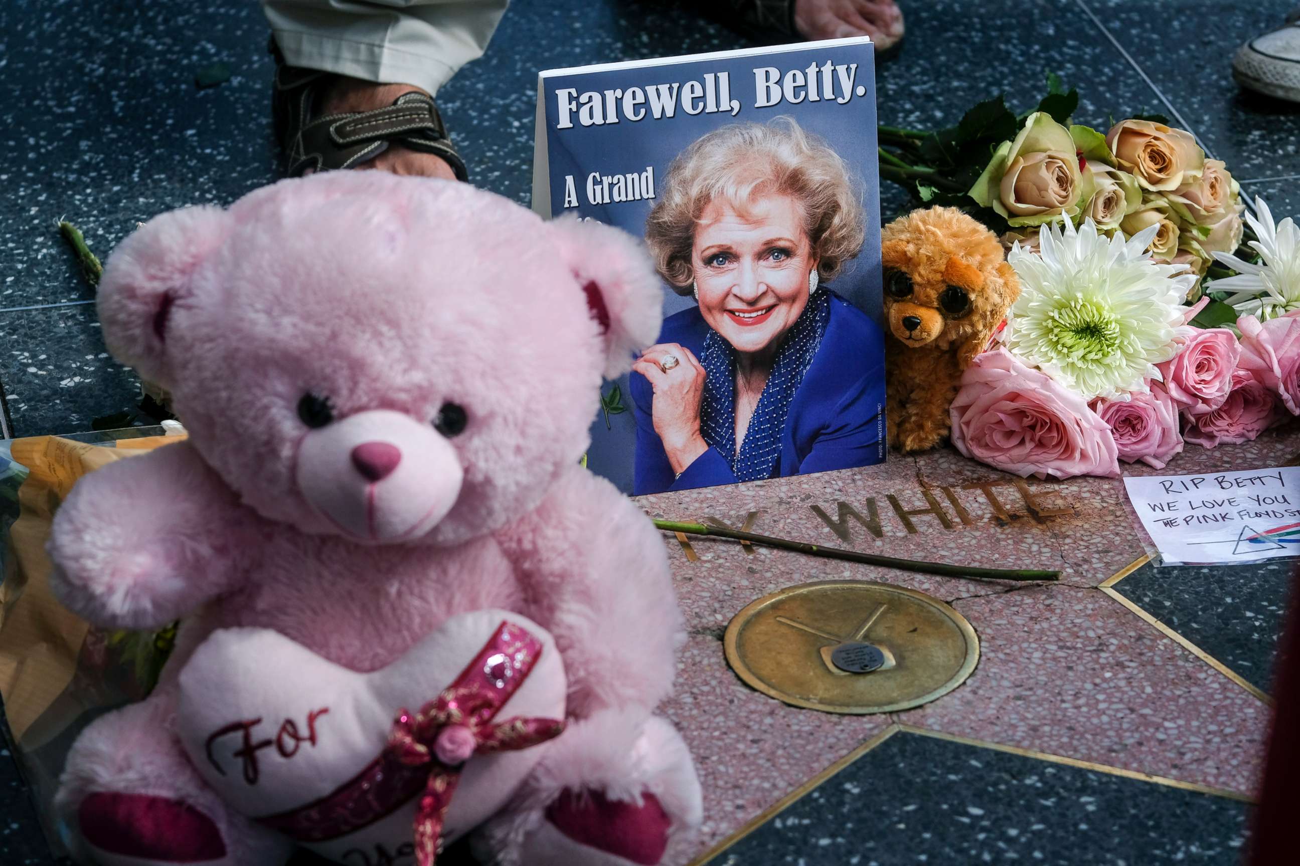 PHOTO: Flowers, stuff toys and cards are displayed at the Hollywood Walk of Fame star of the late actress Betty White, Dec. 31, 2021, in Los Angeles.