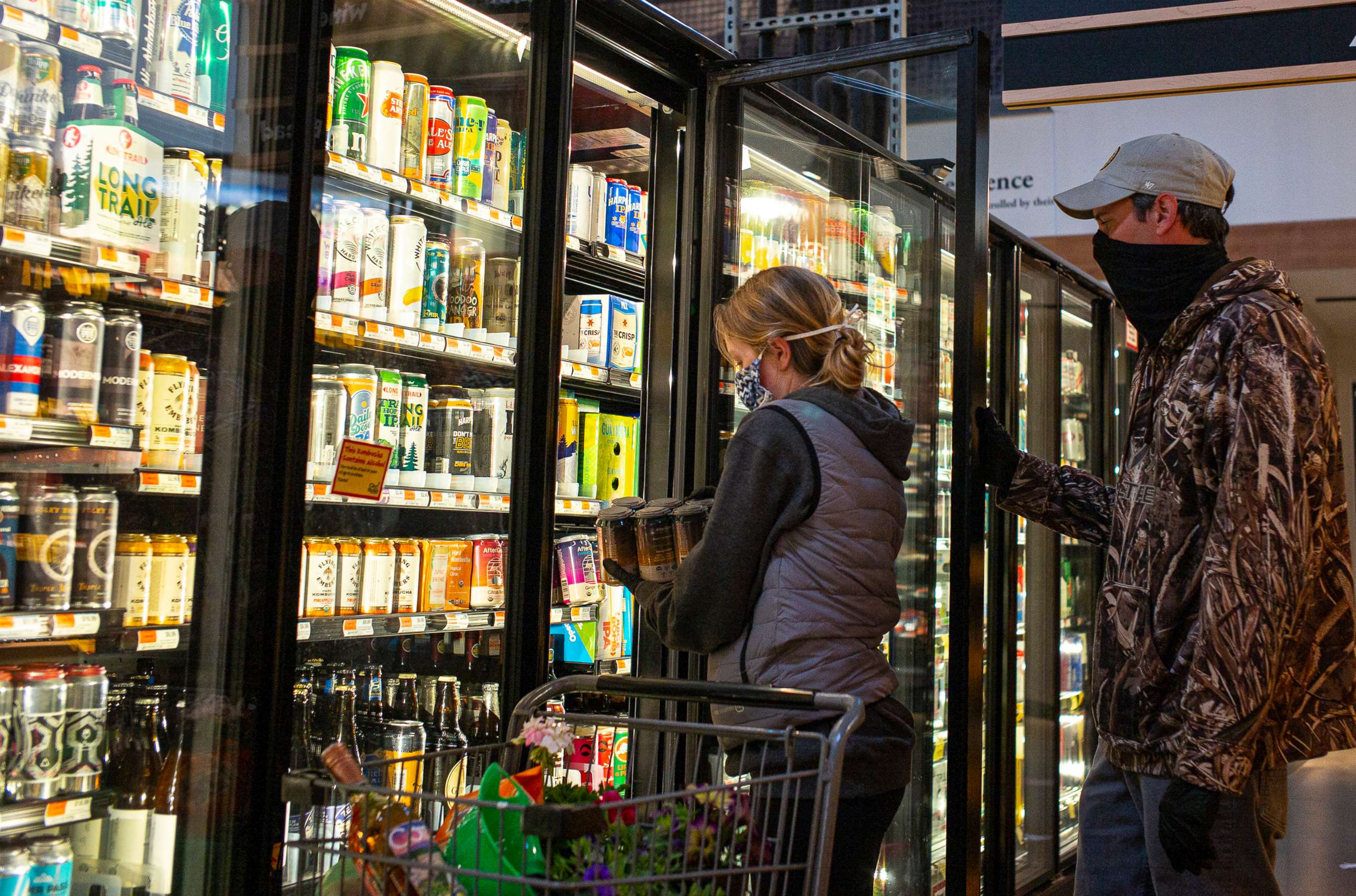 PHOTO: In this May 9, 2020 file photo shoppers at the City Market select beer from a supermarket cooler  in South Burlington, Vt.