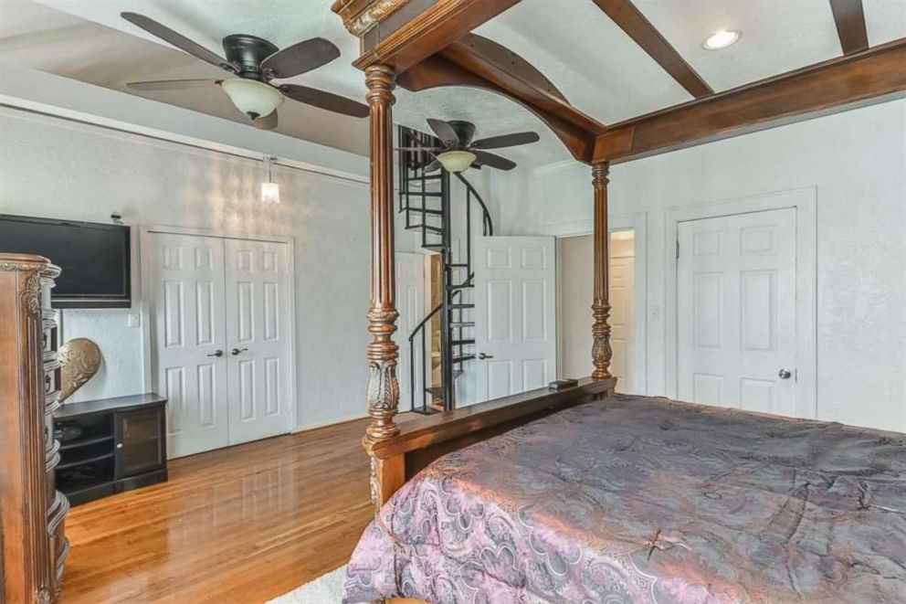 PHOTO: The former childhood home of Beyonce features a master bedroom with raised bed platform & spiral staircase to a third-floor loft.