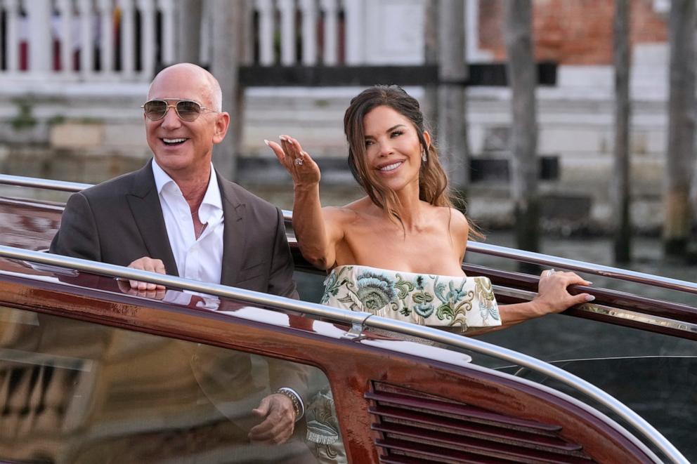 PHOTO: Jeff Bezos, left, and Lauren Sanchez leave a hotel for their pre-wedding reception, in Venice, Italy, June 26, 2025. 