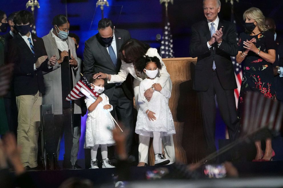 PHOTO: Vice President-elect Kamala Harris and her husband Doug Emhoff are joined onstage by their family as President-elect Joe Biden and his wife Jill Biden applaud in Wilmington, Del., on Nov. 7, 2020.