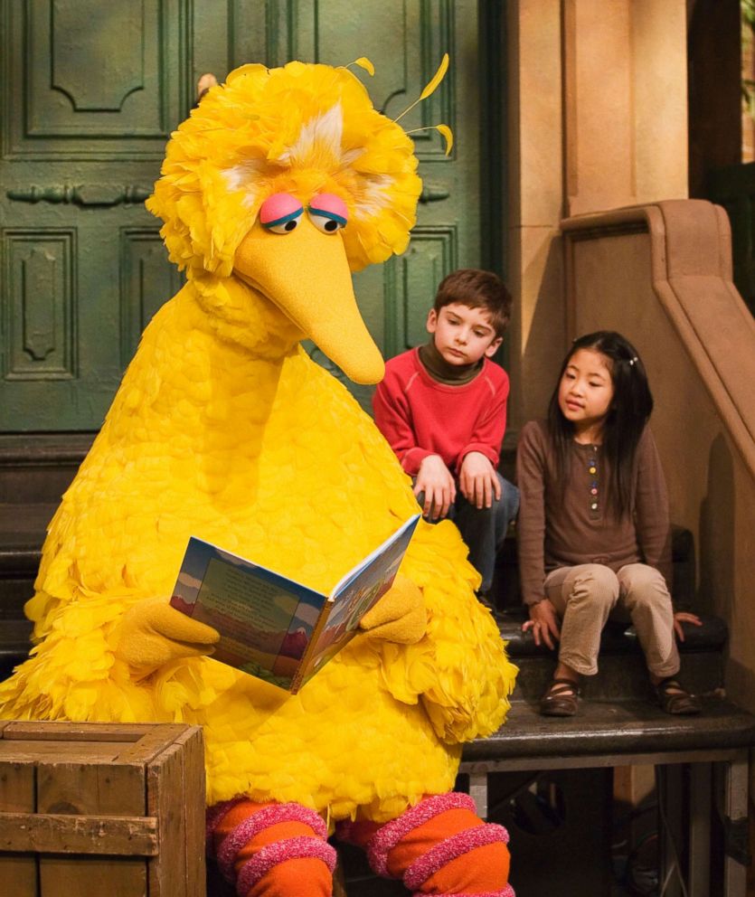 PHOTO: Big Bird reads to Connor Scott and Tiffany Jiao during a taping of Sesame Street in New York, April 10, 2008. Caroll Spinney, the puppeteer who has played Big Bird on "Sesame Street" is retiring after nearly 50 years on the show. 