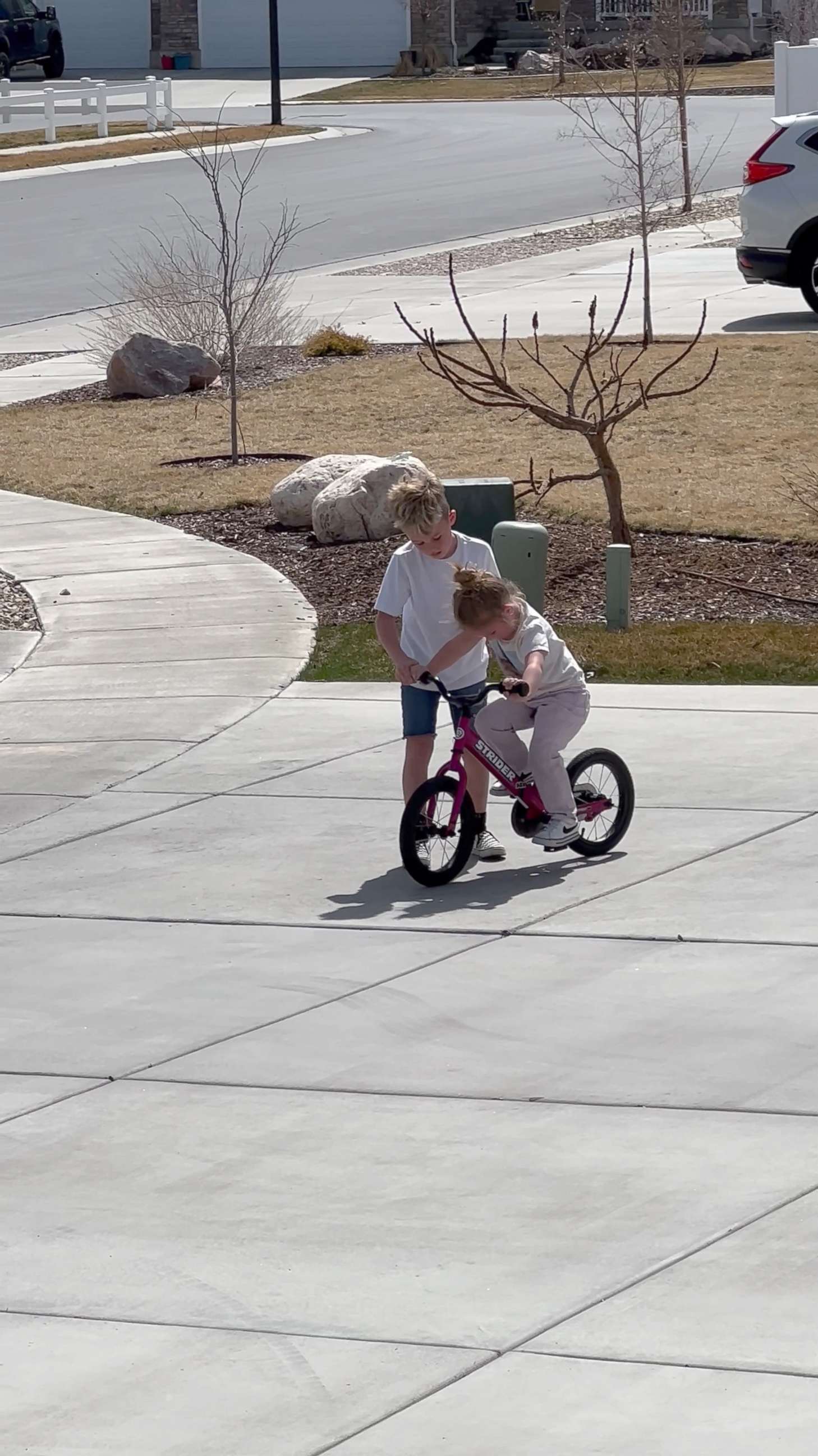 PHOTO: Mak helped his younger sister Judy learn how to ride her bicycle in March.