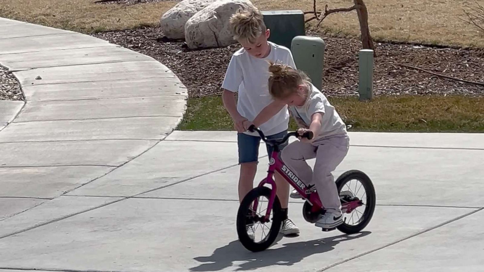 PHOTO: Mak helped his younger sister Judy learn how to ride her bicycle in March.