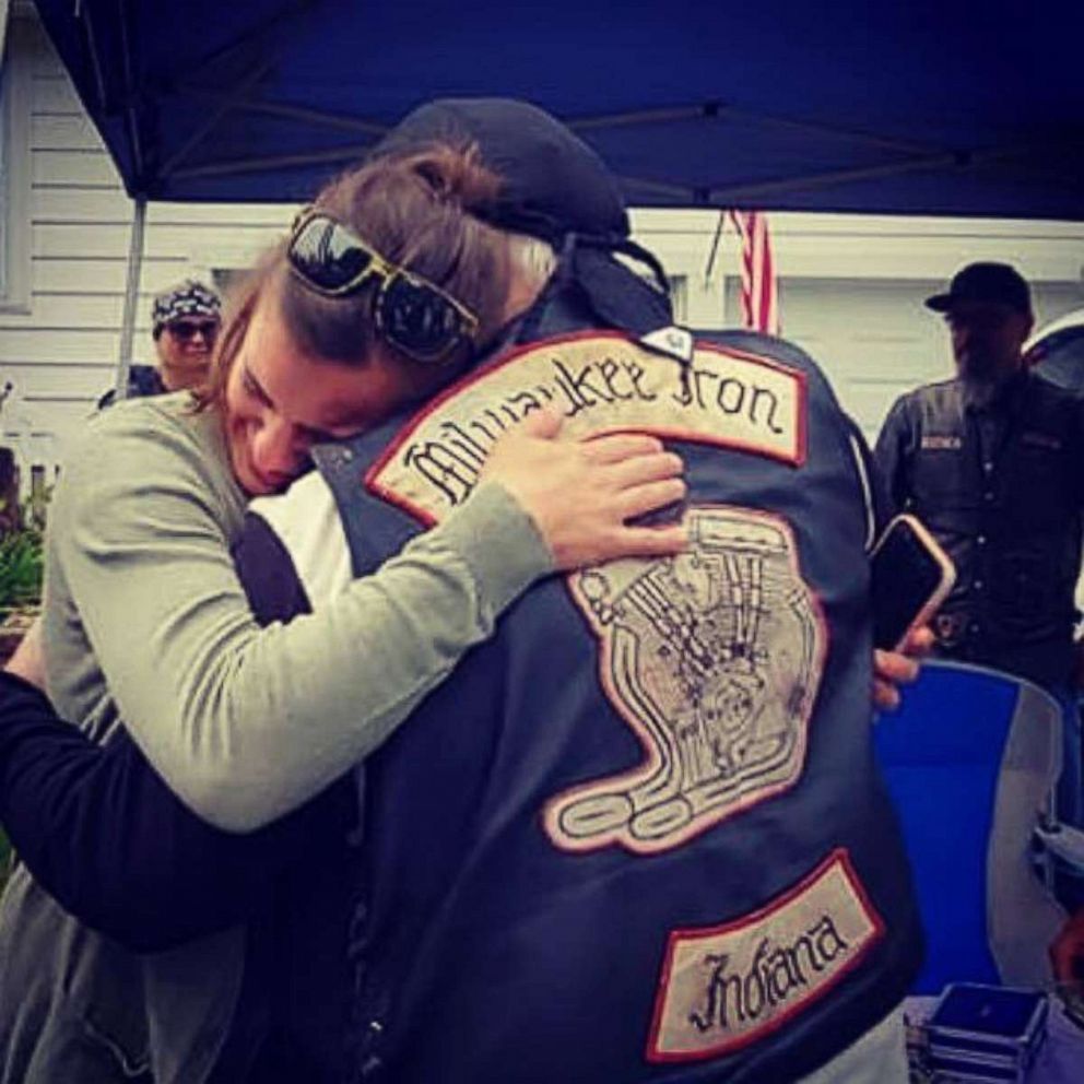 PHOTO: Daryn Sturch of Denver, Indiana, exchanges hugs with a member of the Milwaukee Iron motorcyle group, whom she helped after a motorcycle crash in 2018.