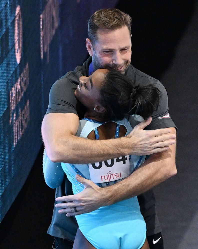 PHOTO: Simone Biles celebrates with coach Laurent Landi after landing a double pike vault during the Women's Vault Qualification, Oct. 1, 2023, during the FIG Artistic Gymnastics World Championships in Antwerp, Belgium.