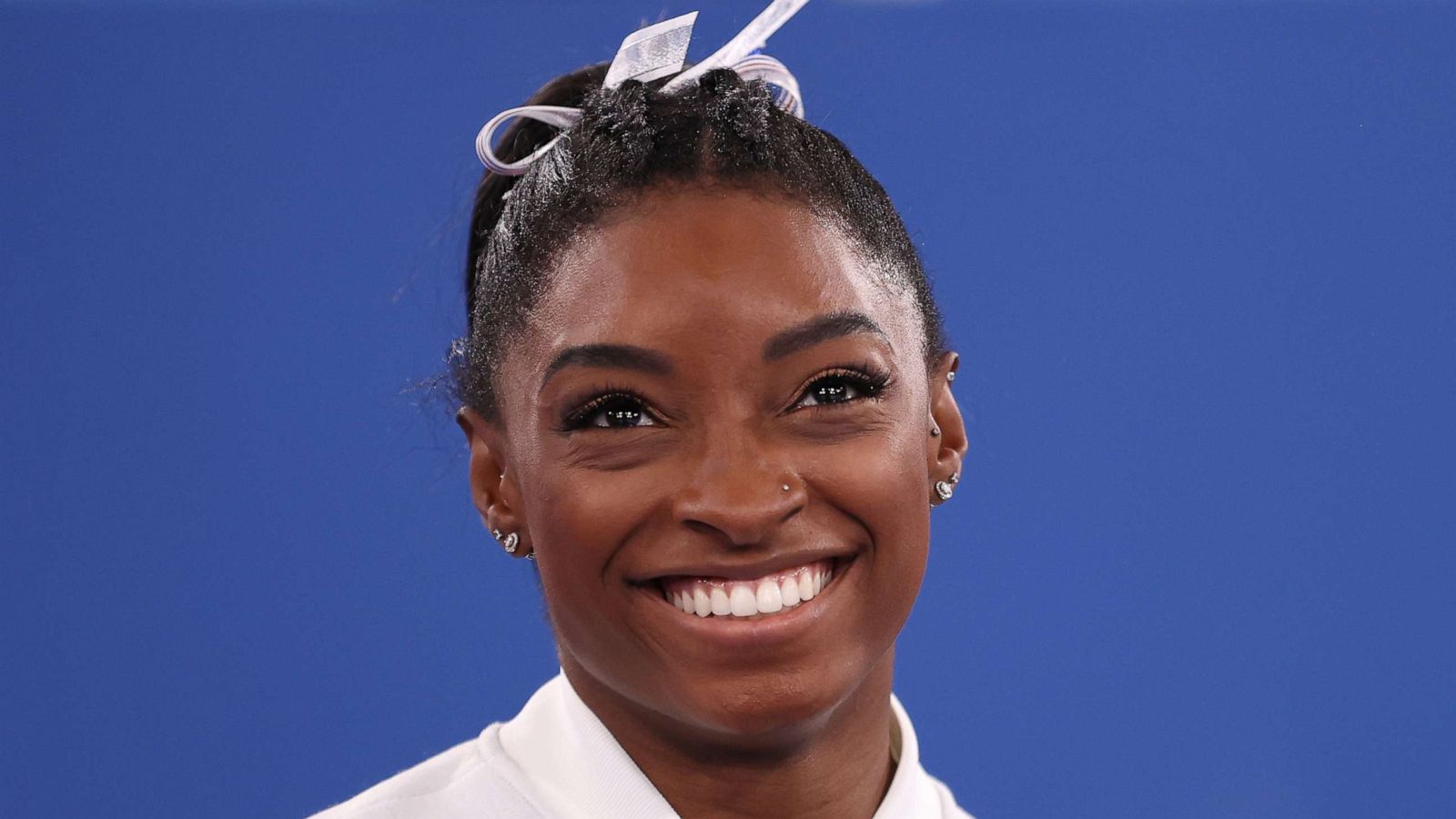 PHOTO: Simone Biles smiles during the Women's Team Final on day four of the Olympics at Ariake Gymnastics Centre on July 27, 2021, in Tokyo.