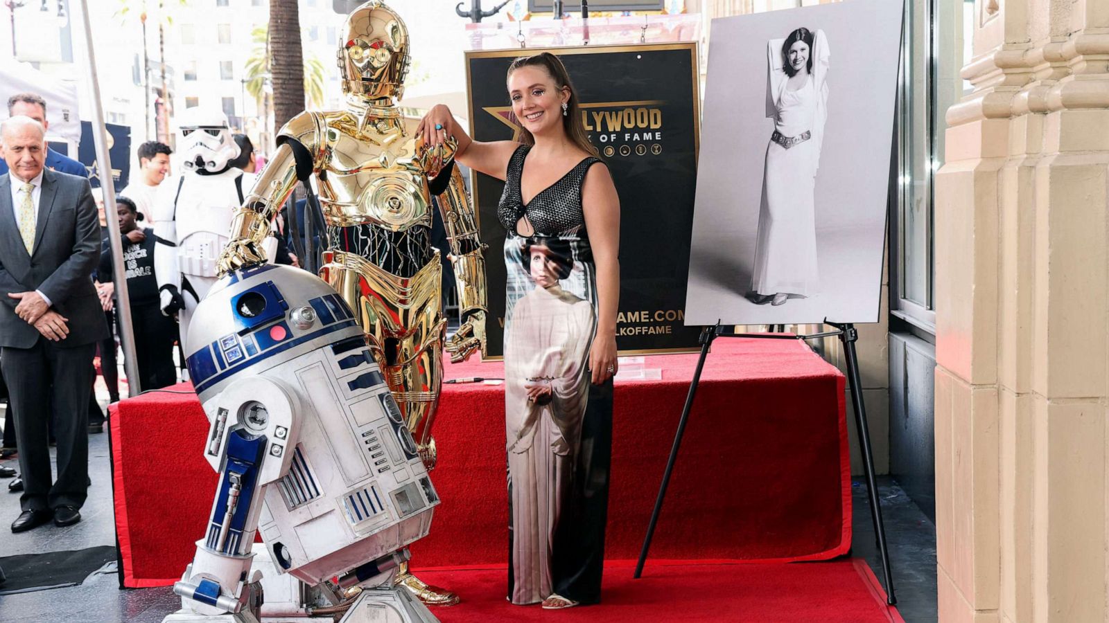 PHOTO: Billie Lourd poses next to Star Wars characters C-3PO and R2-D2 during the posthumous unveiling of the star of actor Carrie Fisher on the Hollywood Walk of Fame in Los Angeles, May 4, 2023.