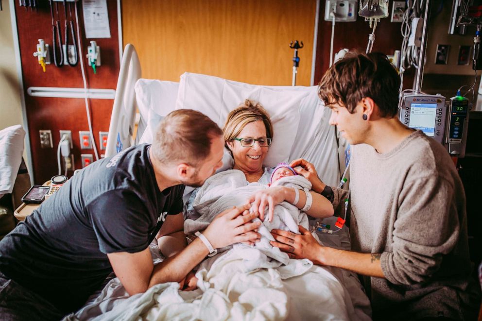 PHOTO: Matthew Eledge, left, and his husband, Elliot Dougherty, pose with their daughter, Uma, and Matthew's mom, Cecile.