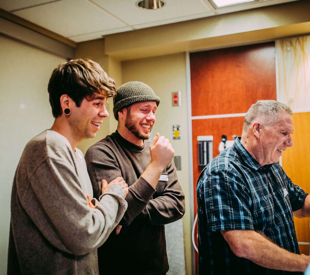 PHOTO: Elliot Dougherty, left, watches the birth of Uma with Matthew Eledge, and his father, Kirk Eledge.