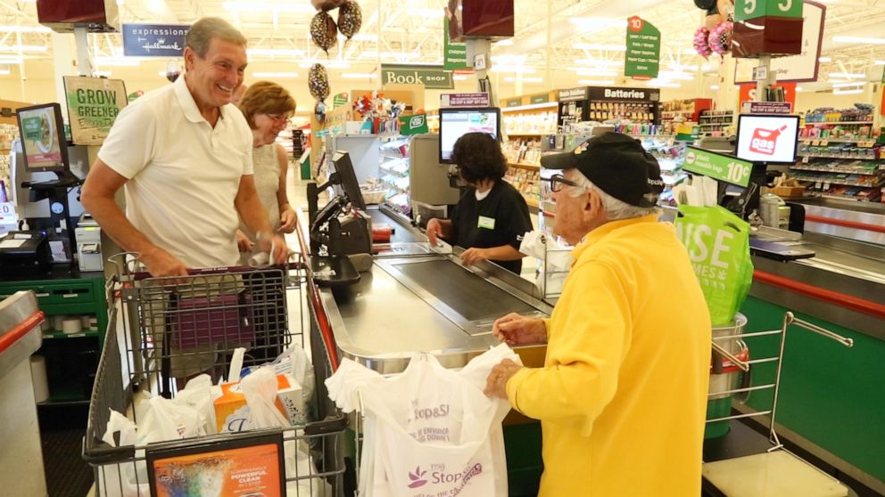 PHOTO: Bennie loves to chat with customers as he bags their groceries.