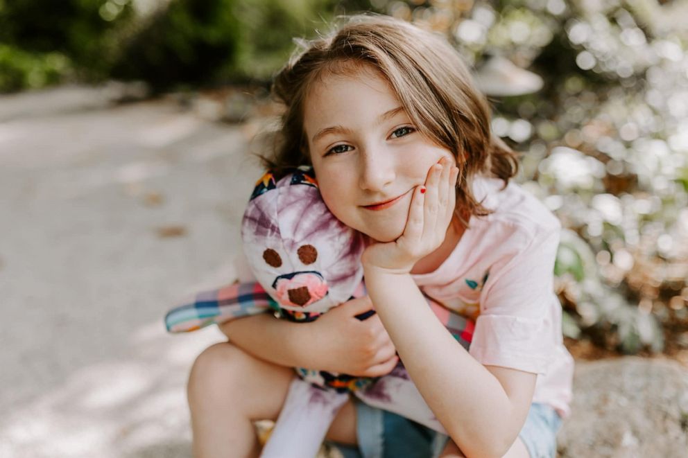 PHOTO: Chloe Sexton hugs her younger sister, Charlotte, who is holding a memory bear plush named "Jenny Wren," after their late mother.