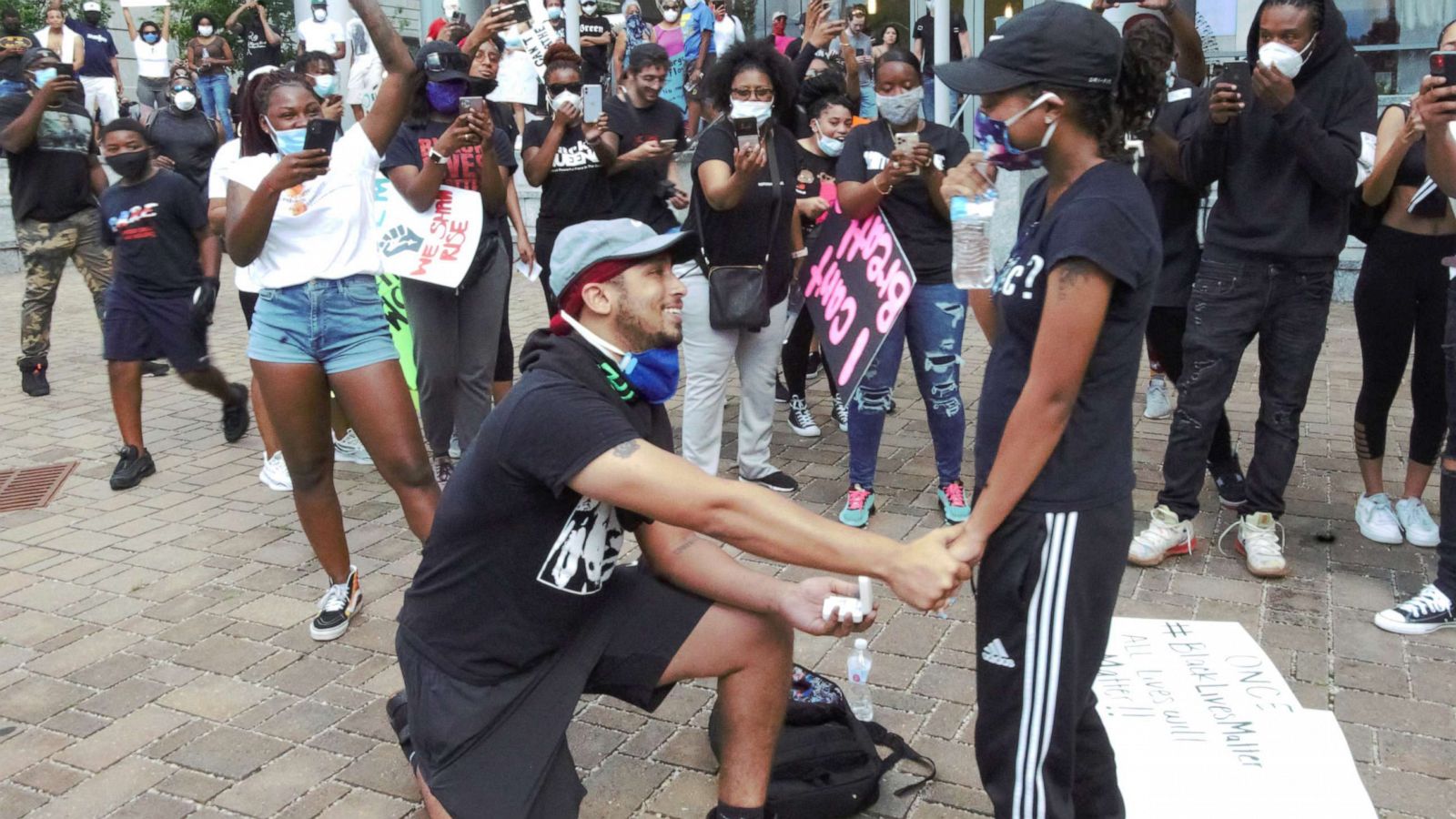 PHOTO: Xavier Young, 26, takes a knee to propose to his girlfriend, Marjorie Alston, 23, during a protest against police brutality and the death of George Floyd, in Raleigh, N.C., on May 30, 2020.