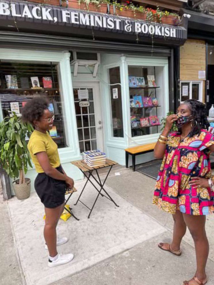 PHOTO: Author Zakiya Dalila Harris (left) of "The Other Black Girl" and Cafe con Libros bookstore owner Kalima DeSuze (right) have a conversation in front of DeSuze's bookstore.
