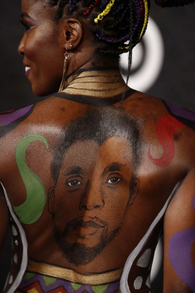 PHOTO: Actress Janeshia Adams-Ginyard, with a portrait of late actor Chadwick Boseman painted on her back, attends the premiere of Marvel's "Black Panther: Wakanda Forever" at the Dolby Theatre in California.