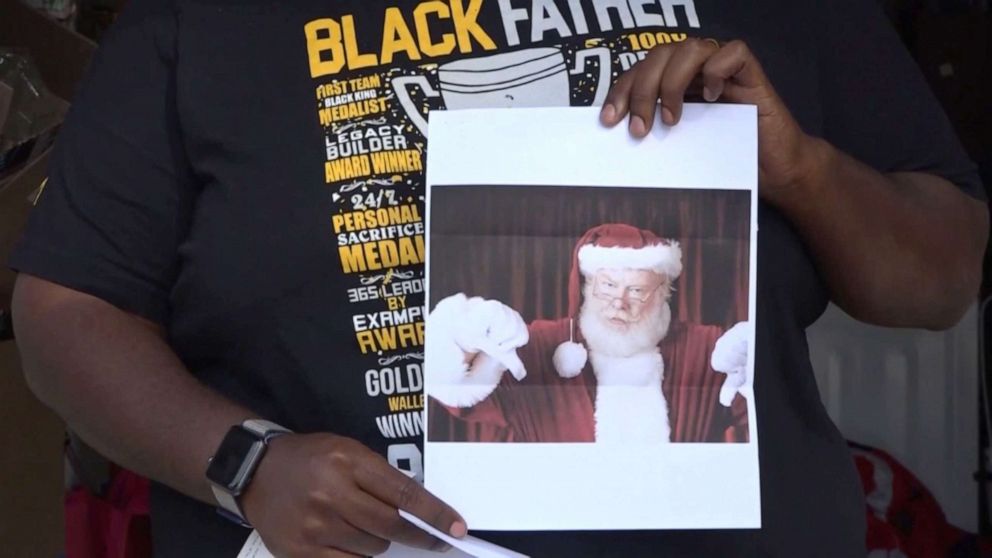 PHOTO: Chris Kennedy is holding a letter claiming to be from Santa Claus and the Lakewood Property Owners Association, asking him to remove his Black Santa Christmas decorations from his home.