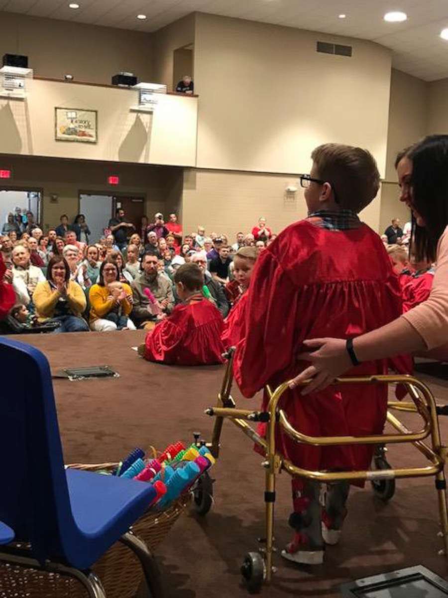 PHOTO: Blake Mompher, 5, walks for the first time across the stage at his graduation ceremony at Crosswoods Preschool graduation in Marion, Ohio, on May 11.