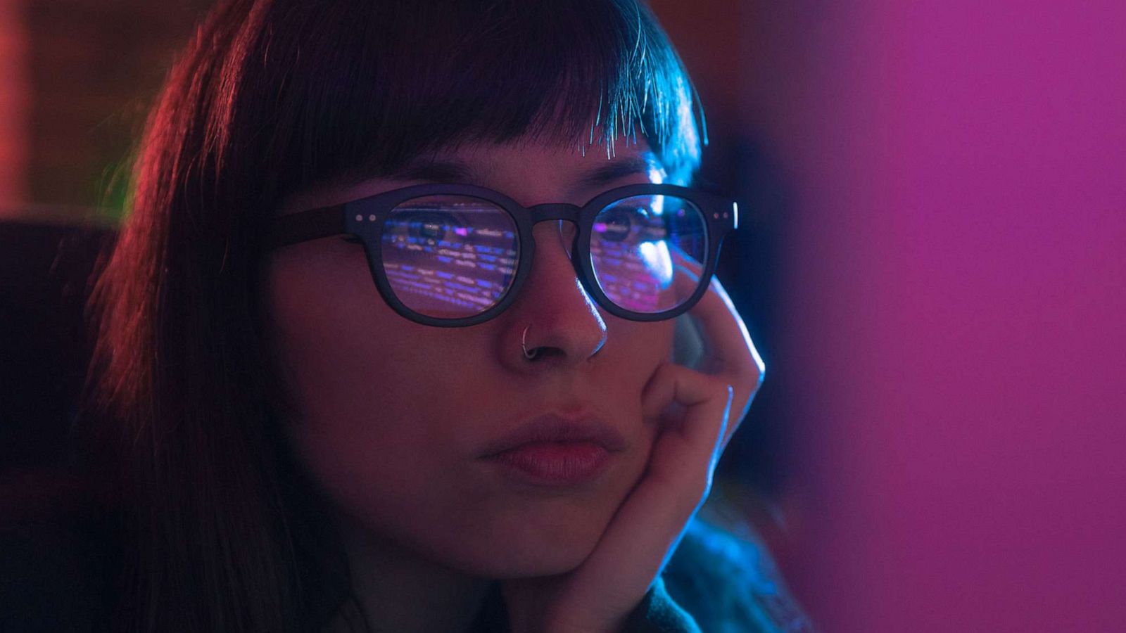 PHOTO: A woman is seen using computer with blue glasses in this stock image.